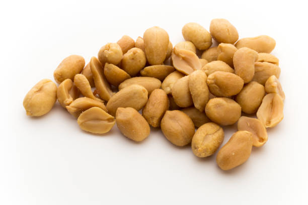 istock Peeled peanuts on the isolated background. 883927268