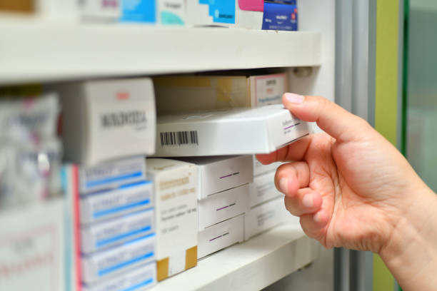 istock Closeup pharmacist hand holding medicine box 883946710