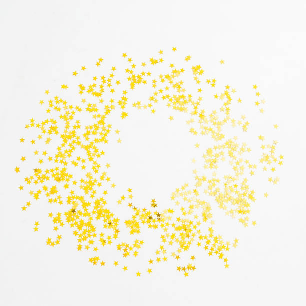 istock Christmas golden confetti on white background. Round frame. Flat lay, top view 883947184