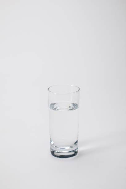 istock transparent glass with calm water on white 883953090