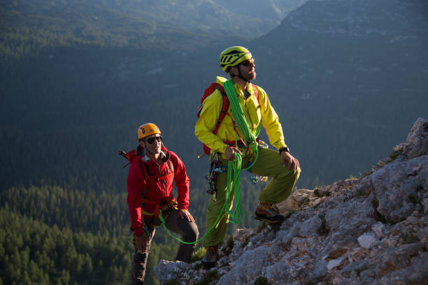 istock Male hikers climbing mountain 883970116