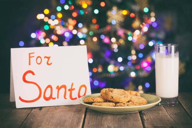 istock Cookies and Milk for Santa on Rustic Wooden Table 883970612