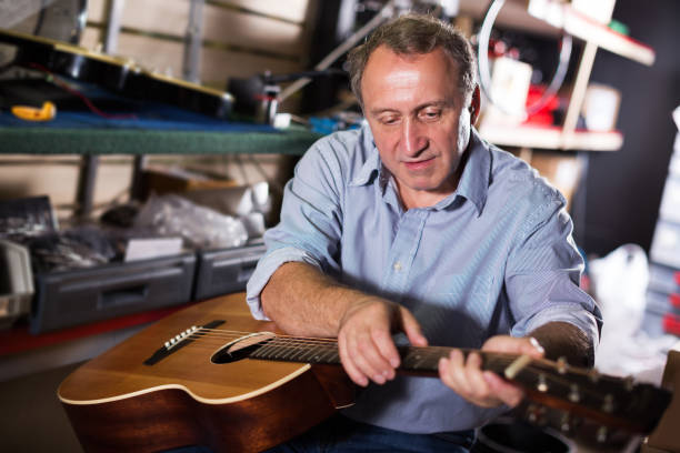 istock male is repairing music instruments 883970658