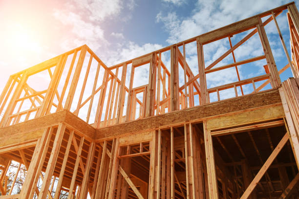 istock New residential construction home framing against a blue sky. 883970782