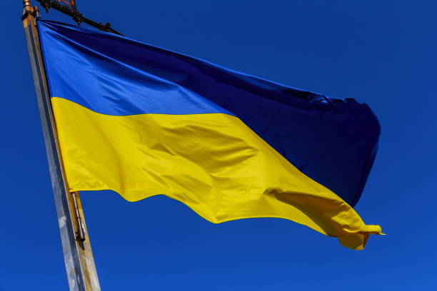 istock Flag of Ukraine on blue sky background. 883970966