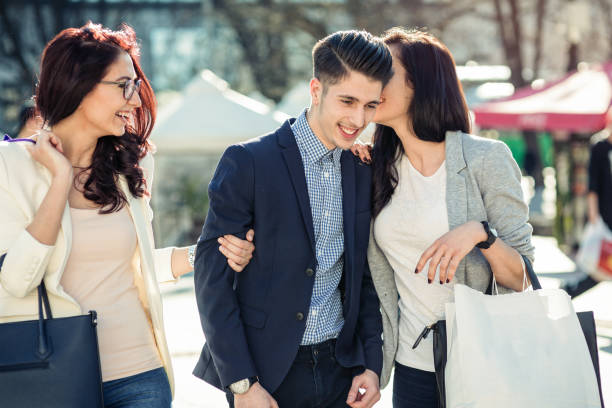 istock Three friends walking on the street and joking 883977596