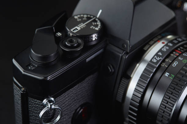 istock Old vintage film camera on dark background 883981628