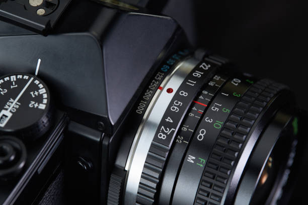 istock Old vintage film camera on dark background 883981712