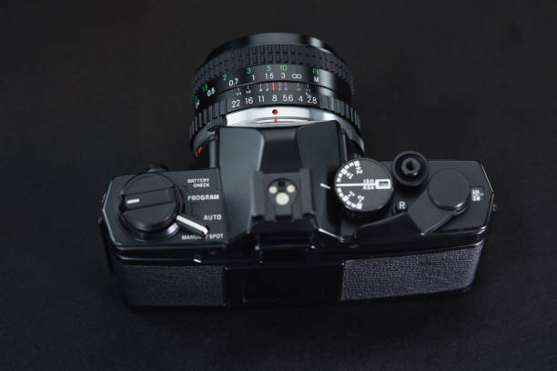 istock Old vintage film camera on dark background 883981842
