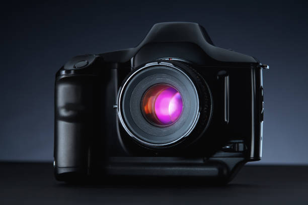 istock Old vintage film camera on dark background 883981904