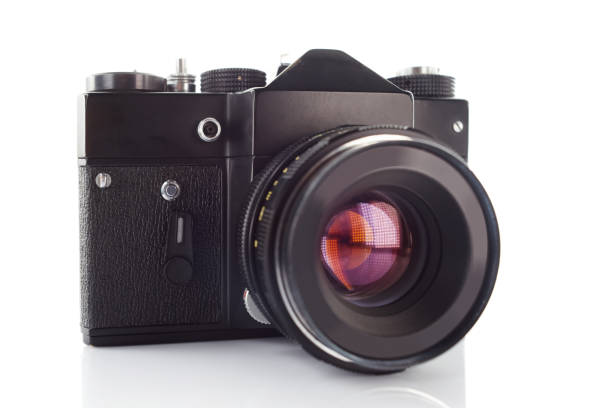 istock Old vintage film camera with lens on white background 883982028