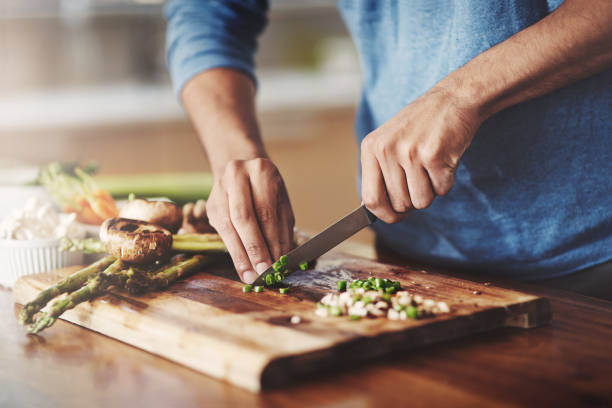 Healthy living is in his hands Cropped shot of a man preparing a healthy meal at home atkins diet stock pictures, royalty-free photos & images