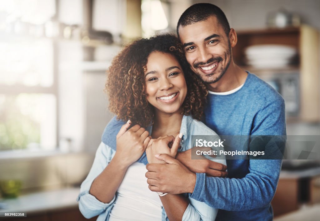 The happiest hearts make the happiest homes Portrait of a happy young couple in their kitchen at home Couple - Relationship Stock Photo