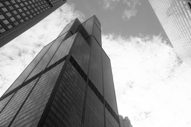 Black and White Chicago Willis Tower Architecture Low Angle View This is a horizontal, black and white photograph of the iconic Willis Tower, previously the Sears Tower in downtown Chicago, Illinois. Photographed from a low angle view. The sky is clear. willis tower stock pictures, royalty-free photos & images