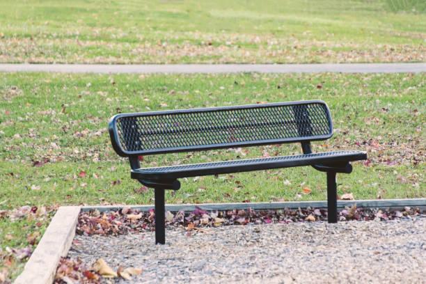 istock park bench in an empty park on a fall morning 883983154