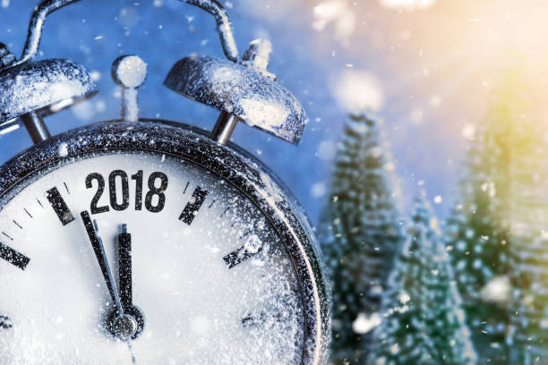 istock New Year 2018 - Celebration With Dial Clock On Snow And Trees 883990524