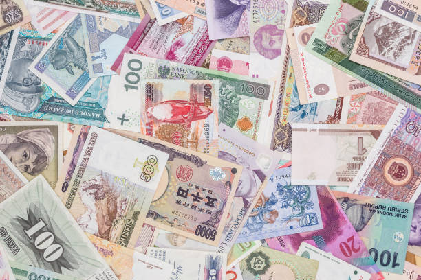 istock world paper money as background. close up 883990550