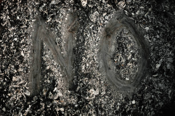 The Word "No" Written In Cigarette Ashes A high angle view of the word "no" written in cigarette ashes. cricket trophy stock pictures, royalty-free photos & images