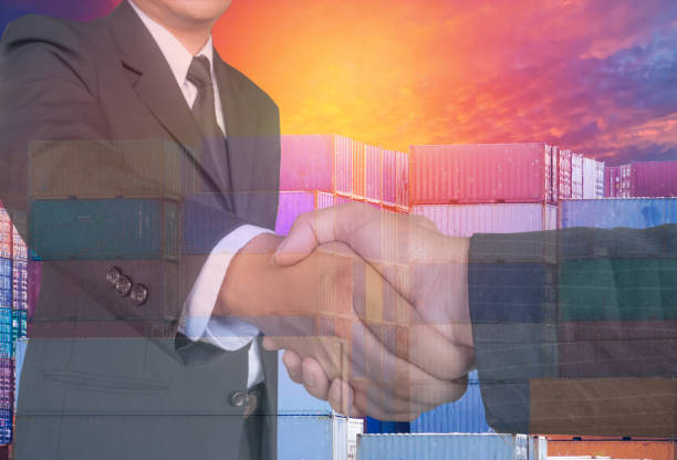 istock Double exposure two businessman hands shake with container and air plane ,business logistick concept. 883990932