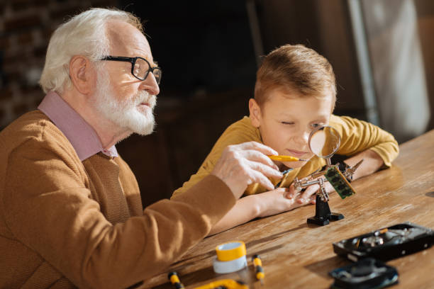 istock Serious senior man pointing with a screwdriver 883991080