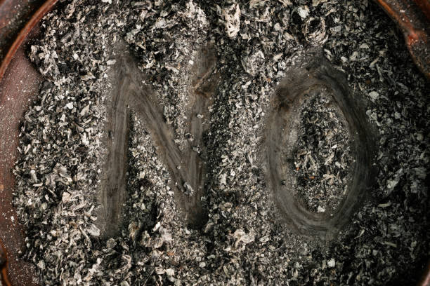 The Word "No" Written With Cigarette Ashes In Ashtray A high angle view of the word "no" written with cigarette ashes in ashtray. cricket trophy stock pictures, royalty-free photos & images