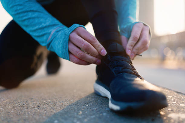 istock Runner trying running shoes getting ready for run 884000958