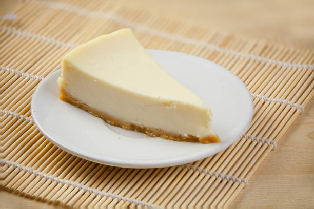 istock classic cheesecake on white plate on  wooden table 884007542