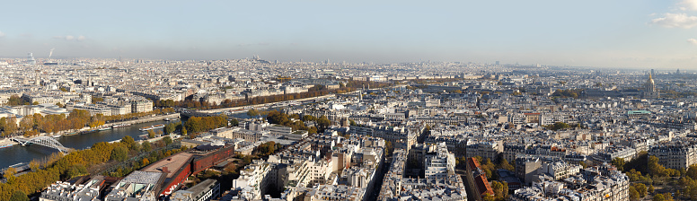 Cityscape of Paris City. Aerial panoramic view of Paris roofs and Seine river as seen from Eiffel Tower in autumn time