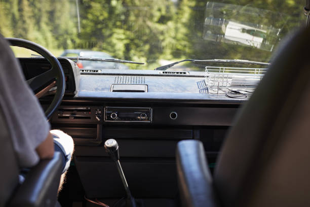 istock Man sitting in an old0 camper. Driving on mountain tracks 884008730