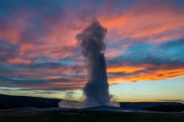 istock Old faithful geyser erupting at sunset 884011076