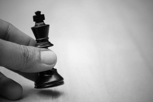 istock Close up of chess player makes a move the black king step forward. Business concept 884012220
