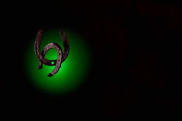 istock HorseShoe rusty steel on dark background 884019628
