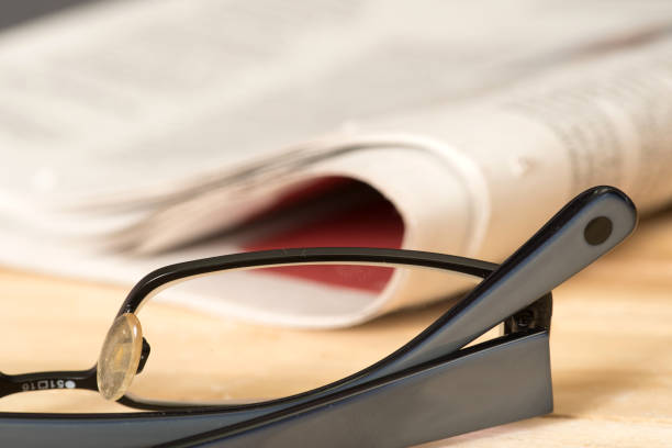 istock Reading glasses and a newspaper 884022414