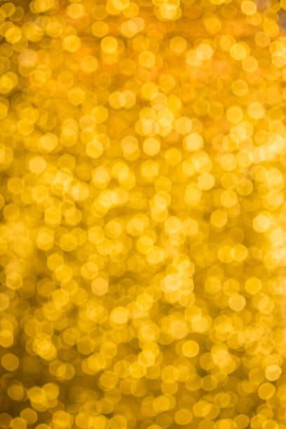 istock blured Christmas light  on gold abstract lights bokeh background 884029506
