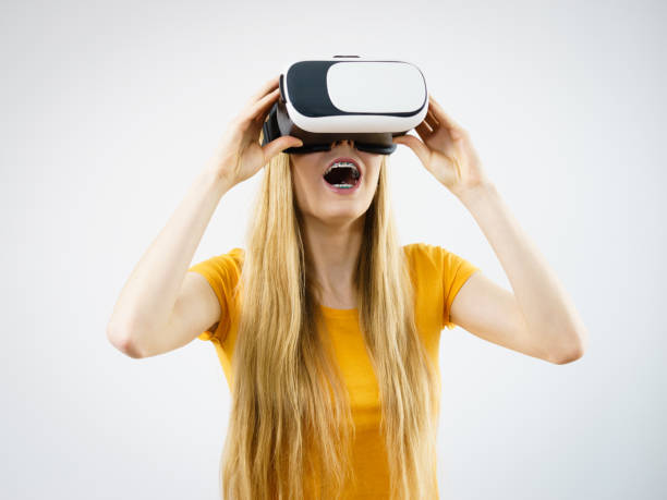 istock Girl wearing virtual reality goggles. 884033918