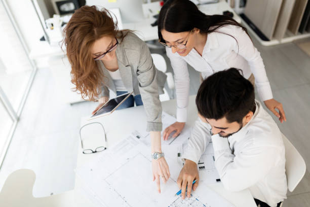 istock Team of architects working together on project 884036026