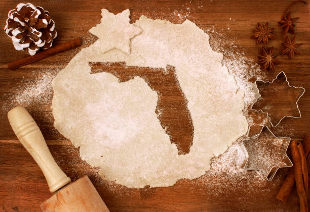 Cookie dough cut as the shape of Florida (series) Festive cookie dough with the shape of Florida cut out (series) florida christmas stock pictures, royalty-free photos & images
