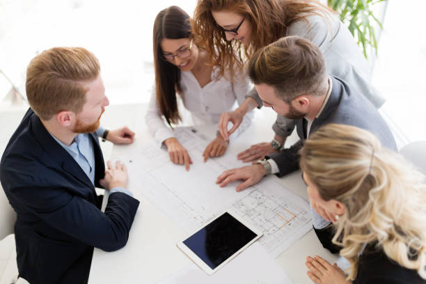 istock Team of architects working together on project 884039358