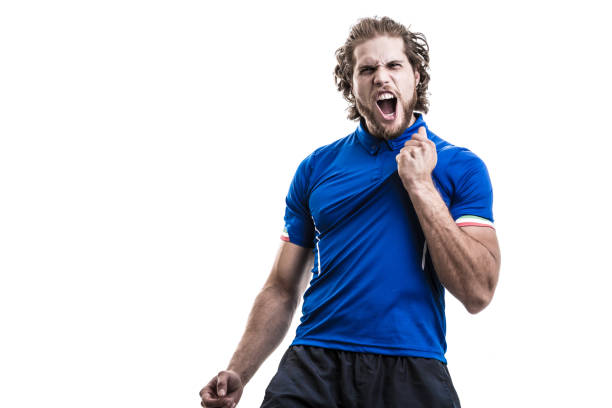 istock Male athlete / fan in blue uniform celebrating on white background 884041870