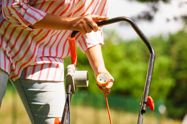 istock Woman being mowing lawn with lawnmower 884042028