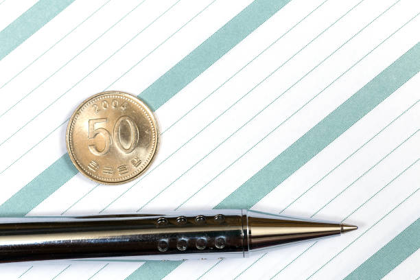 istock Notebook with pen and South Korea 50 won coin 884042256