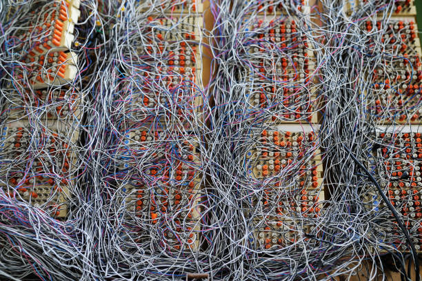 istock Messy cables connections in telecommunication room 884047904