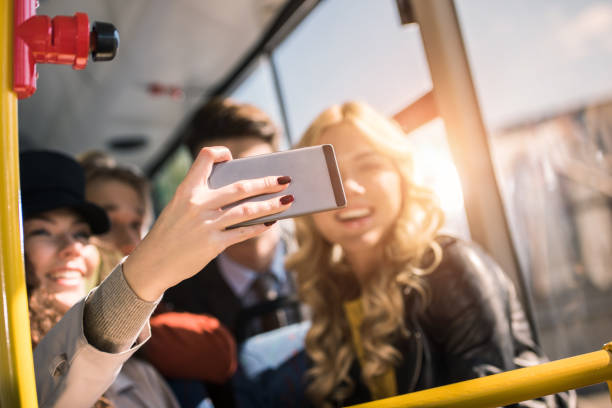 istock friends taking selfie in bus 884048450