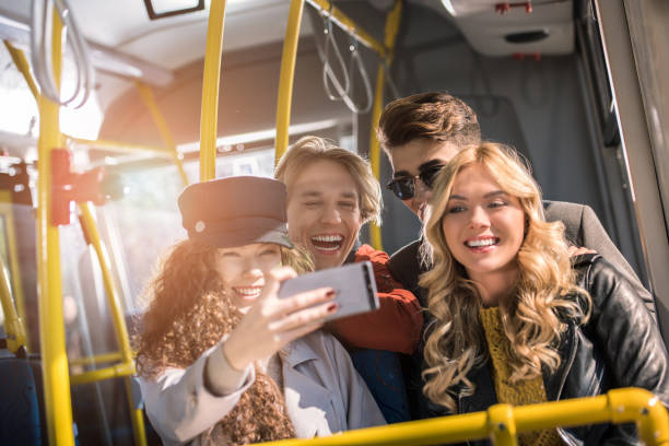 istock friends taking selfie in bus 884048666