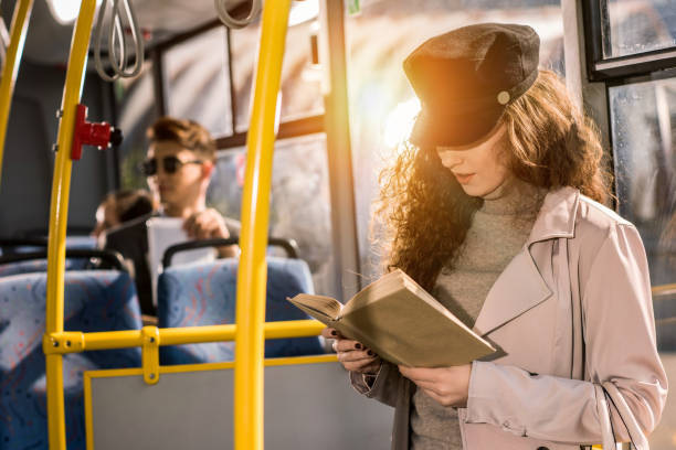 istock girl reading book in bus 884052166