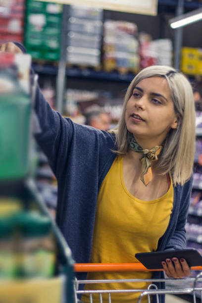 istock Young lady choosing groceries 884055460