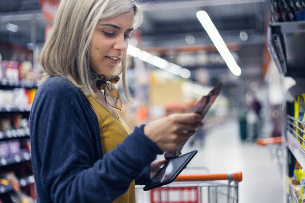 istock Young lady groceries shopping 884055892