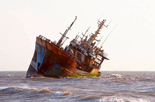Abandoned broken ship-wreck beached on rocky ocean , western sahara coast