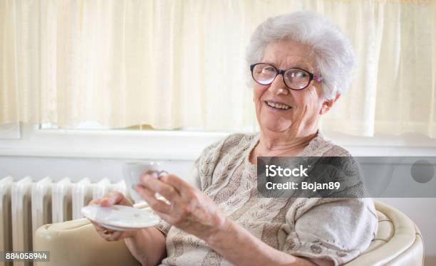 Smiling Grandmother Drinking Coffee At Home Stock Photo - Download Image Now - Grandmother, Senior Women, Portrait