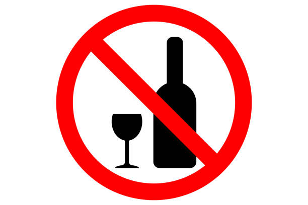 istock ALCOHOL FREE ZONE sign. Whiskey bottle and glass silhouettes in red circle. Vector 884059498